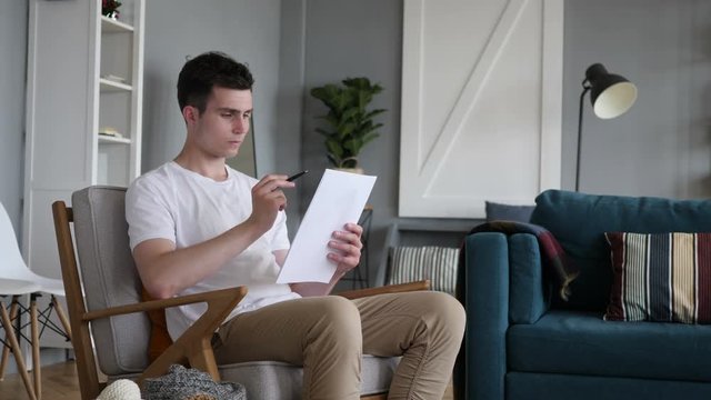 Reading Man Going Through Contract, PaperWork