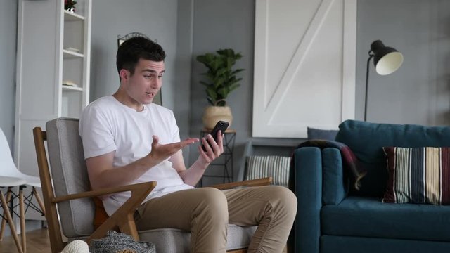 Man Upset for Loss while Using Smartphone