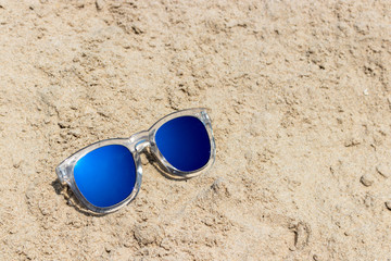 Fototapeta na wymiar Sun glasses with transparent cover on the sand beach