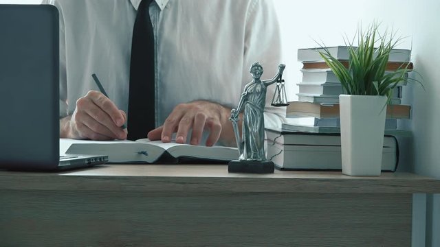 Lawyer writing notes in law firm office