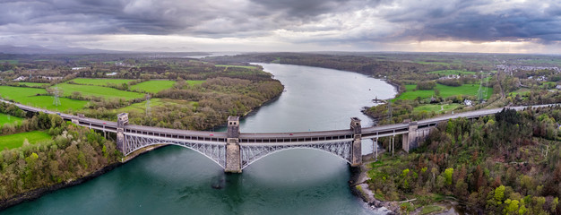 Robert Stephenson Britannia Bridge carries road and railway across the Menai Straits between,...