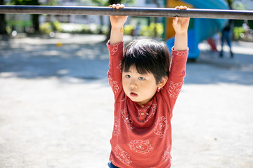 Fototapeta premium 鉄棒で遊ぶ子供