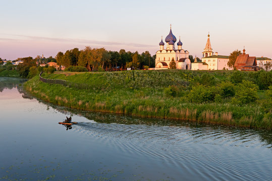 Suzdal town landscape. Suzdal is a gem of the Golden Ring of Russia route, famous tourist destination. Tourists took a Kamenka river paddleboat tour around Suzdal Kremlin.