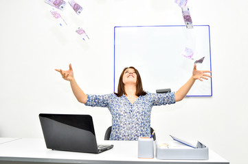 The girl happy brown-haired throws into the air bills 500 euros. Success concept of a young woman.