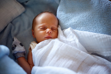 Child sleeping in his crib