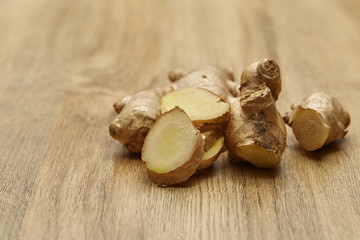 Ginger root sliced on wooden table