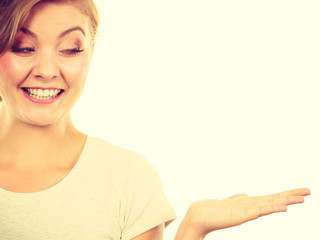 Happy blonde woman presenting with palm hand