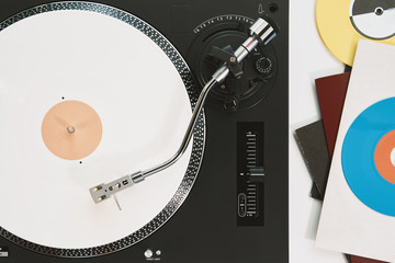 Turntable vinyl record player on the background white wooden boards. Sound technology for DJ to mix...