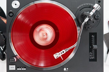 Turntable vinyl record player on the background white wooden boards. Sound technology for DJ to mix...