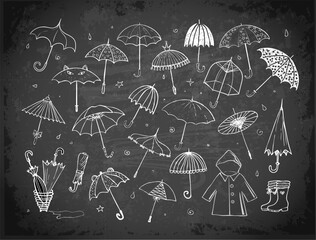 Set of doodle sketch umbrellas on blackboard background © elinacious