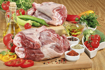 raw lamb leg on board