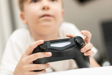 Close up of kid playing video games.