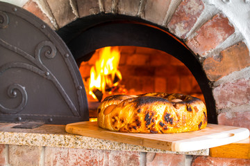 Rustic home-made Neapolitan Easter dish called casatiello napoletano containing salami and pecorino...