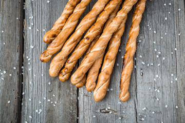 Homemade cheese bread sticks on a light wooden background