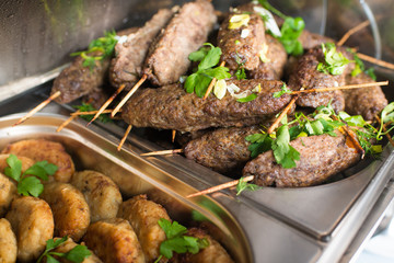 Hot meat cutlets in bowl on the buffet table