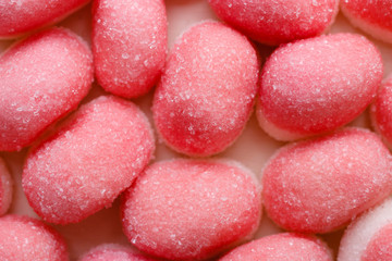 Pink jellies or marshmallows as background