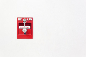 Fire alarm. Fire break glass alarm switch on the white wall. Security system red fire alarm box.