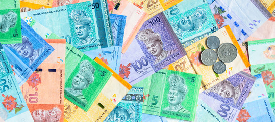 Malaysian ringgit banknotes and coins background. Financial concept.