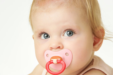
Studio portrait of adorable baby girl with pacifier
