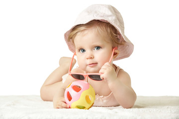 
Studio portrait of adorable baby girl wearing pink plastic sunglasses, isolated on the white background, summer vacation concept