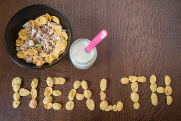 Healthy food, cornflakes in plate and glass with yogurt
