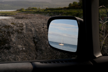 Boat reflected in car mirror