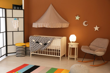 Stylish baby room interior with crib