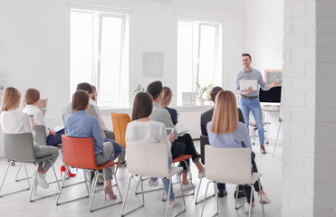 Male business trainer giving lecture in office