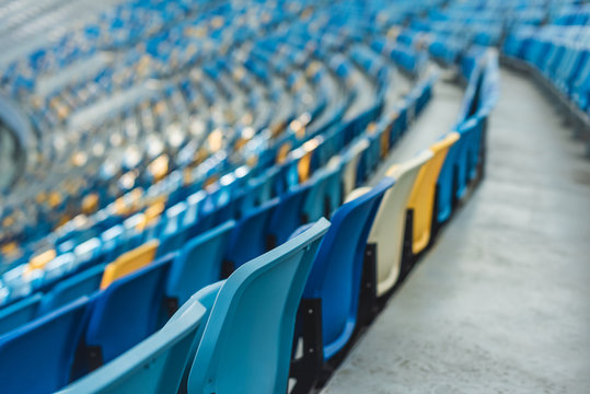 empty colorful seats on tribunes of modern stadium