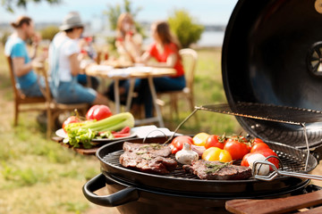Modern grill with meat and vegetables outdoors, closeup - obrazy, fototapety, plakaty