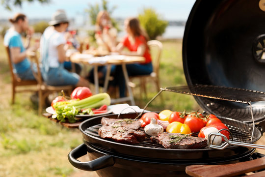 Modern grill with meat and vegetables outdoors, closeup