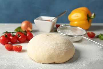 Fototapeta na wymiar Fresh dough and ingredients for pizza on table