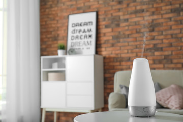 Aroma oil diffuser on table at home. Air freshener - obrazy, fototapety, plakaty