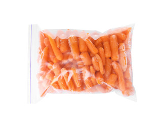 Plastic bag with frozen baby carrots on white background, top view. Vegetable preservation