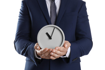 Young businessman holding clock on white background. Time management