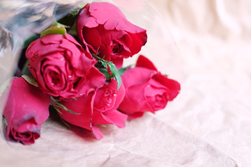 Pink roses Bouquet on brown crumpled paper background.Valentine's day holiday concept. Copy space