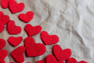 Red paper hearts shape on brown crumpled paper background, Top view.Valentine's day holiday concept. Copy space