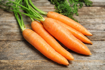 Ripe carrots on wooden background. Healthy diet
