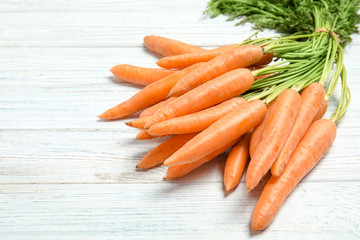 Ripe carrots on wooden background. Healthy diet