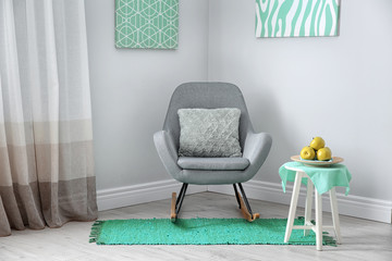 Living room interior with comfortable armchair. Mint color decors
