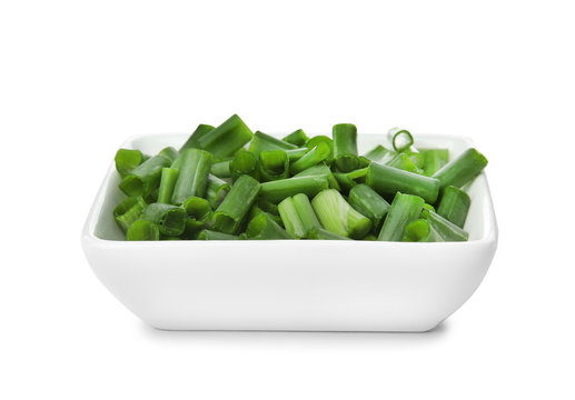 Bowl with chopped green onion on white background