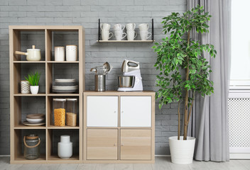 Different cooking utensils and dishes in modern kitchen