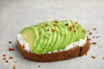 Crisp rye toast with sliced avocado and cream cheese on table © New Africa