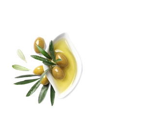 Dish with oil, olives and leaves on white background
