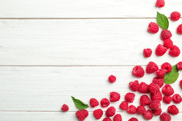 Ripe aromatic raspberries on wooden table, top view