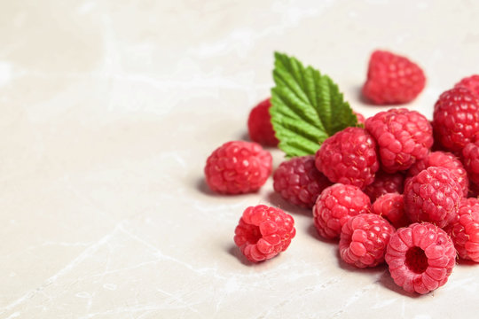 Ripe aromatic raspberries on table, closeup