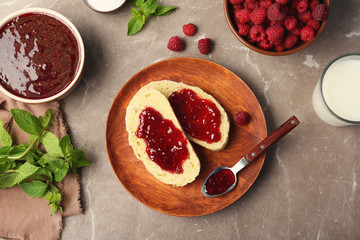 Beautiful composition with delicious raspberry jam on table, top view