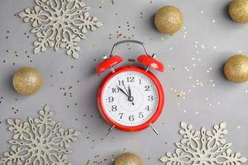 Flat lay composition with alarm clock and decorations on grey background. Christmas countdown