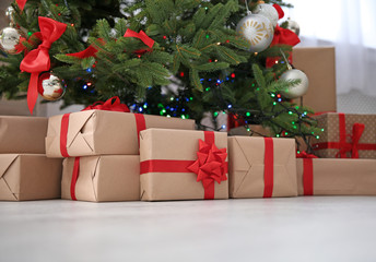 Fototapeta na wymiar Beautiful Christmas tree with gift boxes indoors