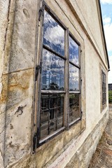 Historic window with old wavy glass and wooden frame